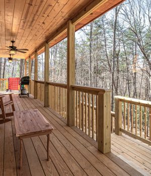 Covered cabin porch with forest views near Cabins in Murphy NC