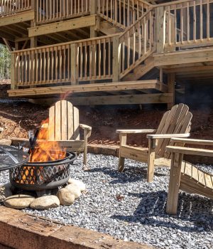 Outdoor fire pit seating below a private Cabin Rental deck